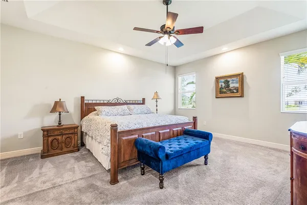 a spacious bedroom with a bed and a chandelier