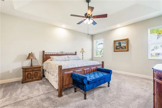 a spacious bedroom with a bed and a chandelier