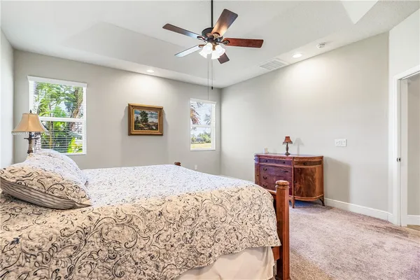 a bedroom with a bed dresser and a window