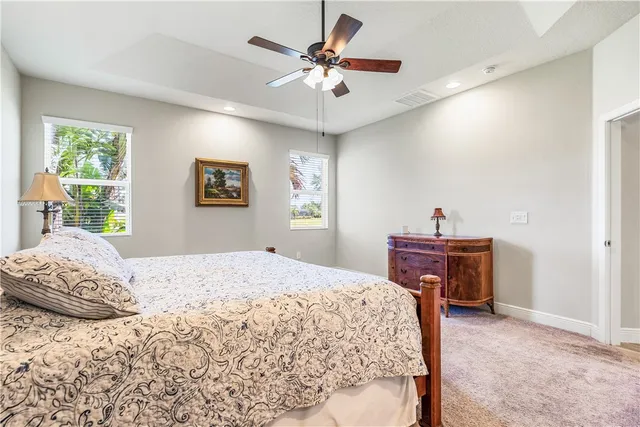 a bedroom with a bed dresser and a window