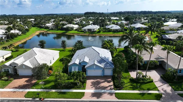 an aerial view of a house with a yard and lake view