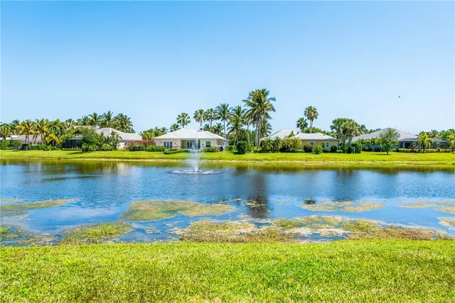 a view of a lake with houses in the back
