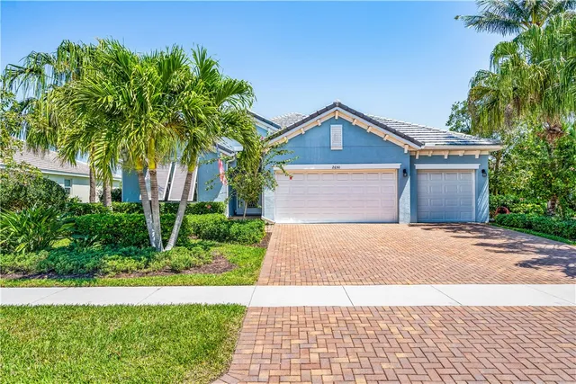 a front view of a house with a yard and a garage