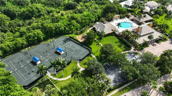 an aerial view of a house with a yard