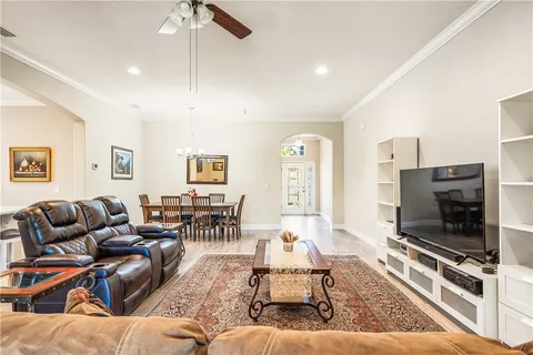 a living room with furniture a flat screen tv and a fireplace