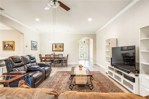 a living room with furniture a flat screen tv and a fireplace