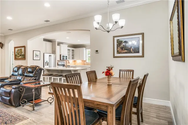 a view of a dining room with furniture and chandelier