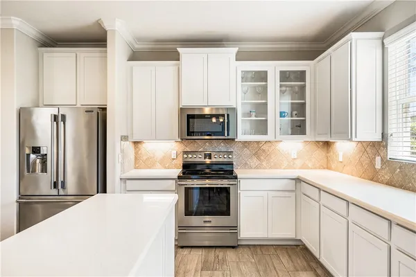 a kitchen with a stove and a refrigerator