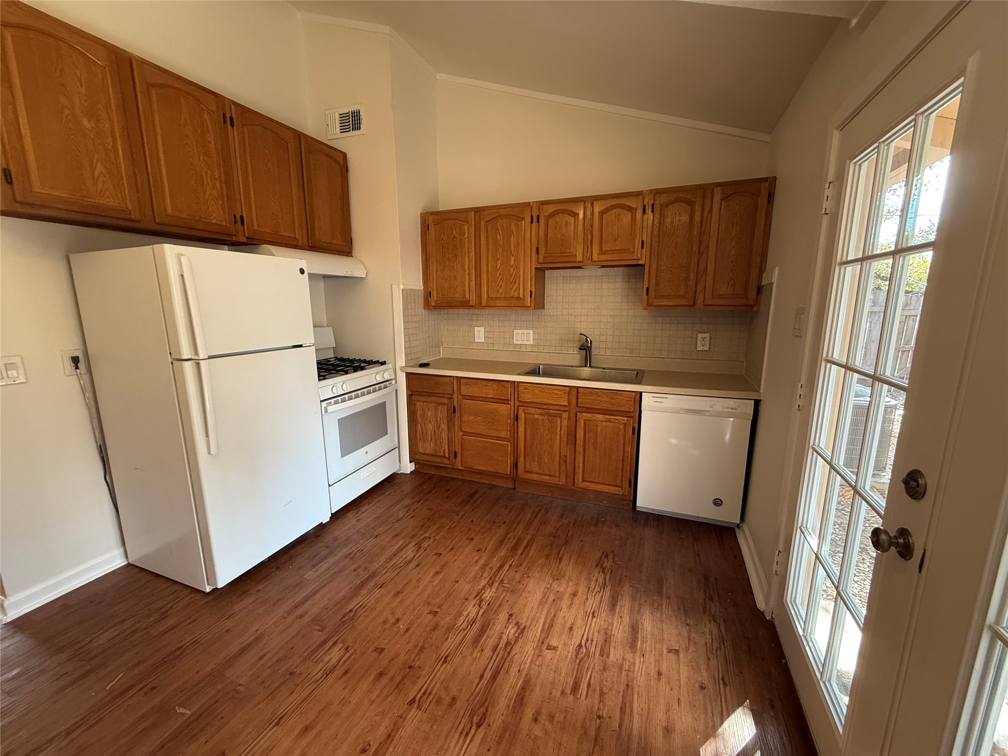 6710 Circle S Road, Unit B Austin, TX 78745 - Photo 11 of 14 a kitchen with white cabinets and white appliances