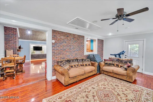 a bedroom with furniture and wooden floor
