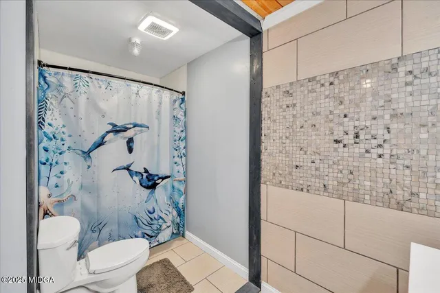 a bathroom with a toilet and shower