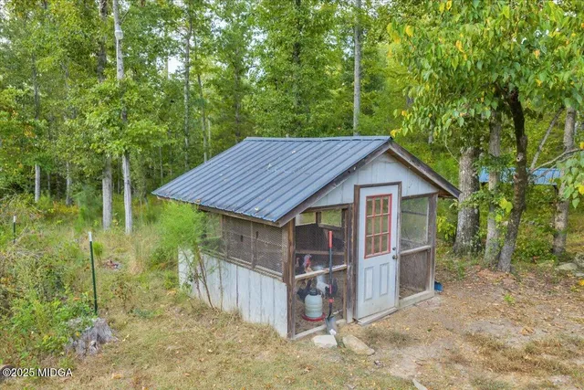 a view of a small house with a yard
