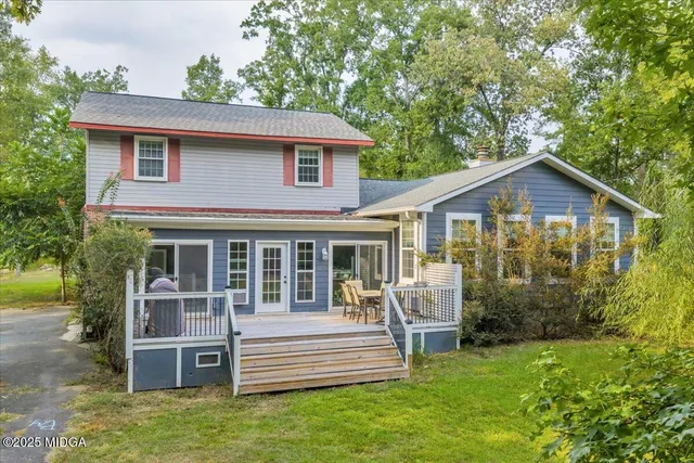 a view of a house with a yard and sitting area