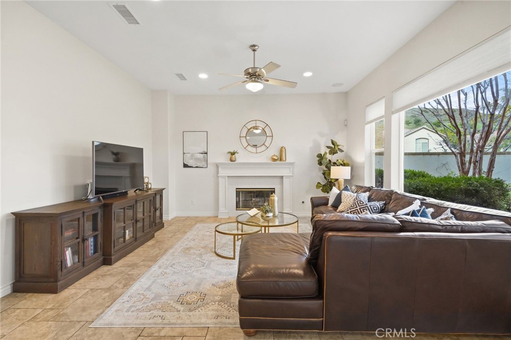 996 Blackbourne Point Oak Park, CA 91377 - Photo 15 of 75 a living room with furniture a fireplace and a flat screen tv