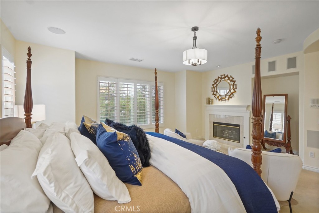 996 Blackbourne Point Oak Park, CA 91377 - Photo 37 of 75 a bed room with a bed and a fireplace