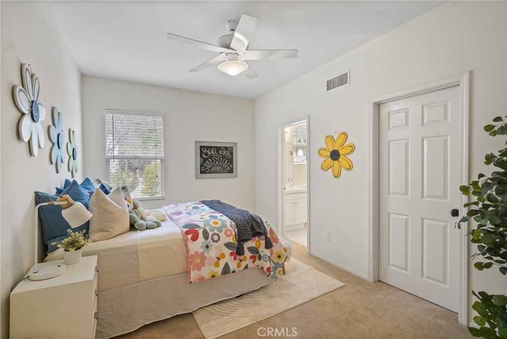 996 Blackbourne Point Oak Park, CA 91377 - Photo 55 of 75 a bedroom with a bed and a chandelier