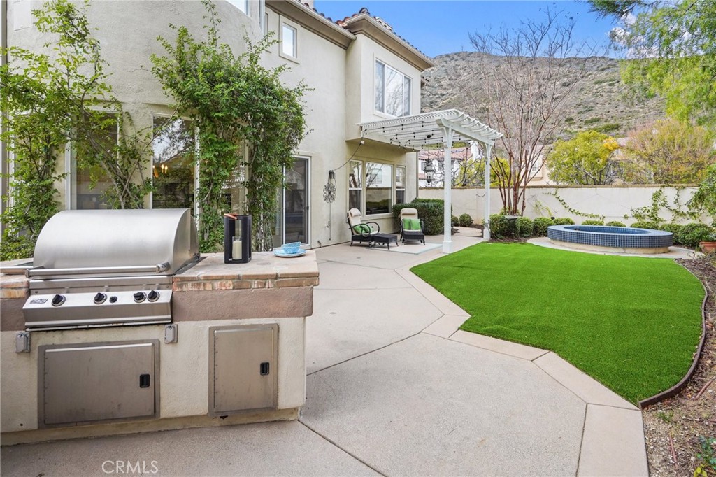 996 Blackbourne Point Oak Park, CA 91377 - Photo 59 of 75 a view of a patio with table and chairs and potted plants
