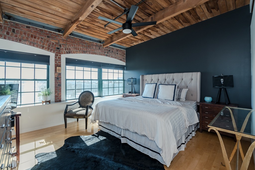 a bedroom with a bed and a large window