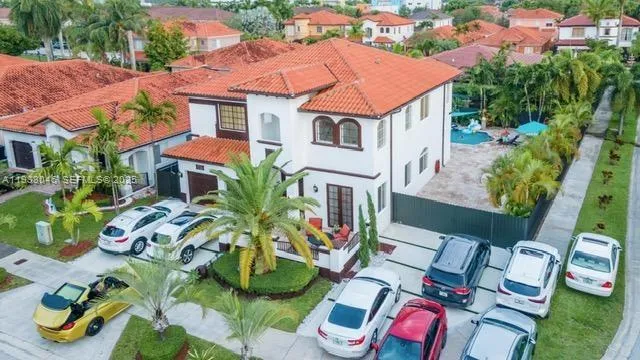 an aerial view of multiple houses with yard
