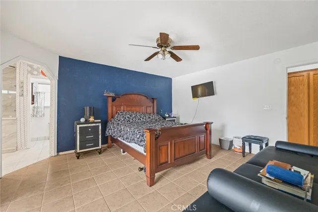 a bedroom with furniture and a window