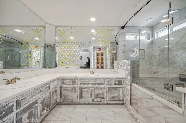 a spacious bathroom with a granite countertop sink mirror and shower