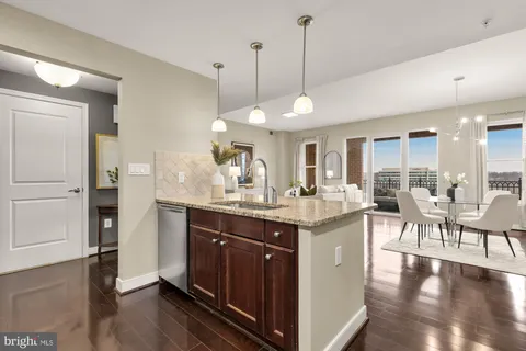 a kitchen with center island table and chairs