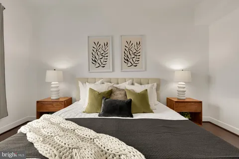 a bed sitting in a bedroom and lamp