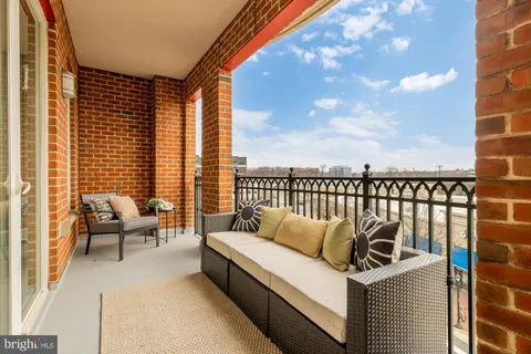 a balcony with furniture and city view