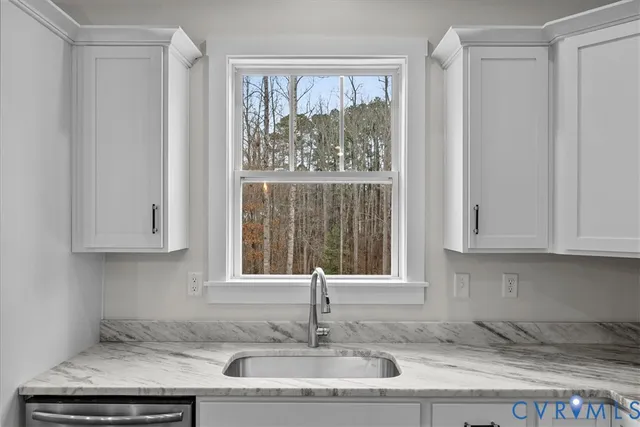 a kitchen with granite countertop a sink and a window