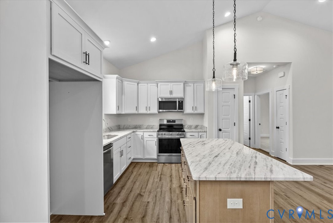 431 Raleigh Avenue South Hill, VA 23970 - Photo 13 of 27 a large kitchen with cabinets stainless steel appliances and a counter top