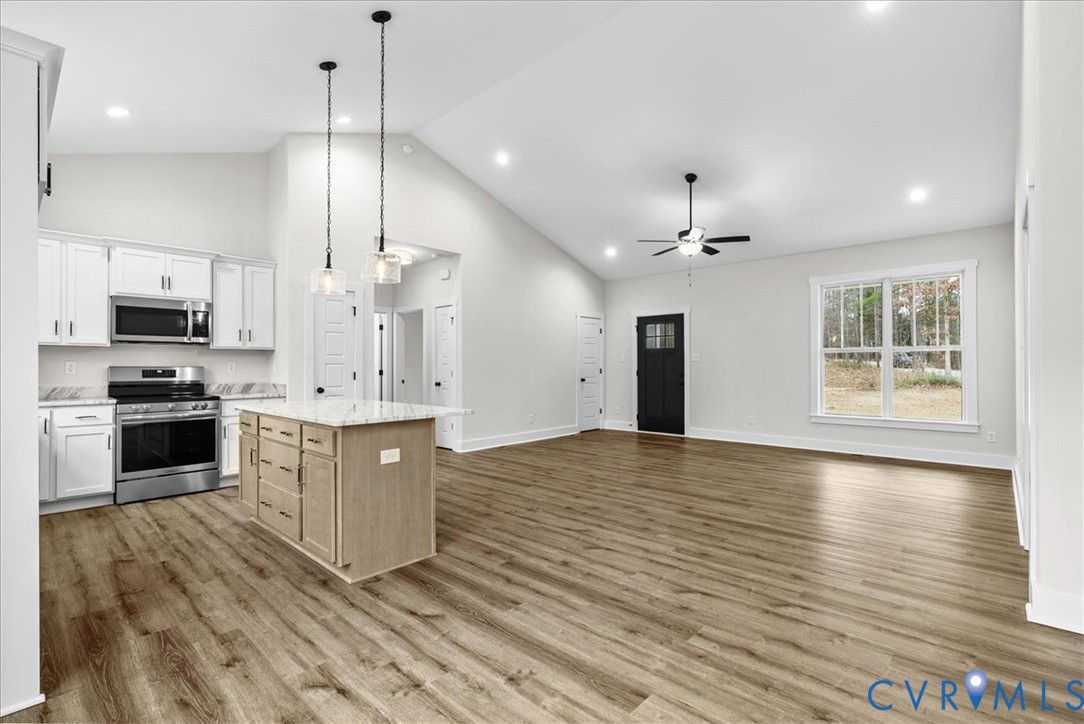 431 Raleigh Avenue South Hill, VA 23970 - Photo 16 of 27 a large kitchen with granite countertop a large center island a sink stainless steel appliances and cabinets