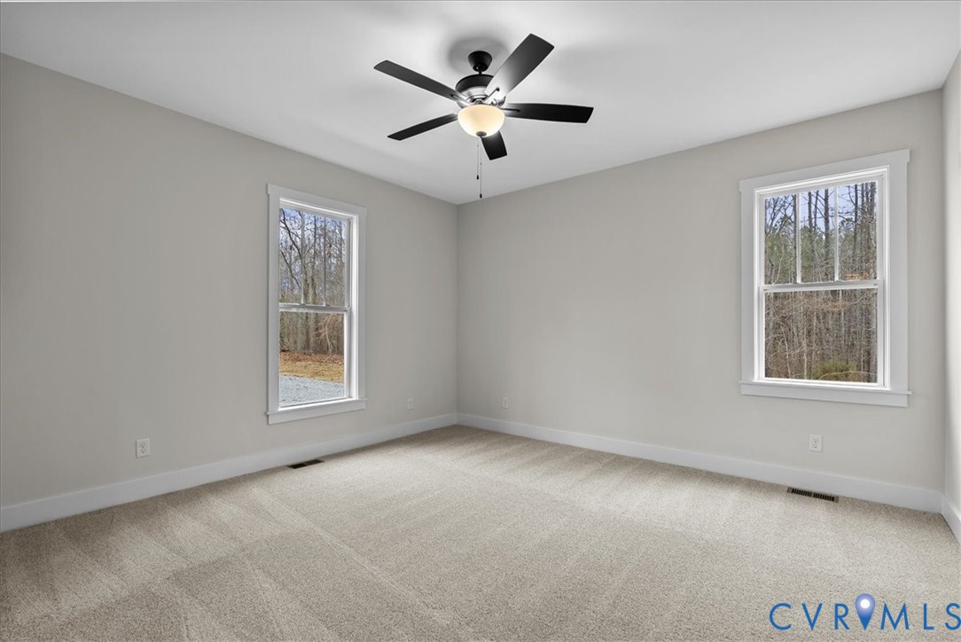 431 Raleigh Avenue South Hill, VA 23970 - Photo 17 of 27 an empty room with windows and ceiling fan