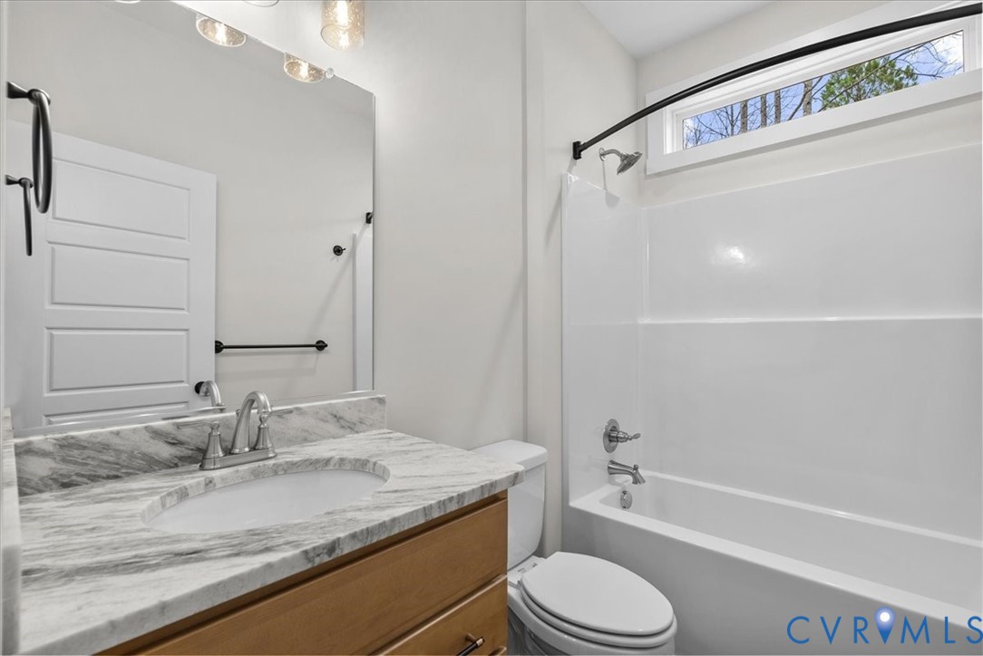 431 Raleigh Avenue South Hill, VA 23970 - Photo 24 of 27 a bathroom with a granite countertop sink toilet and shower