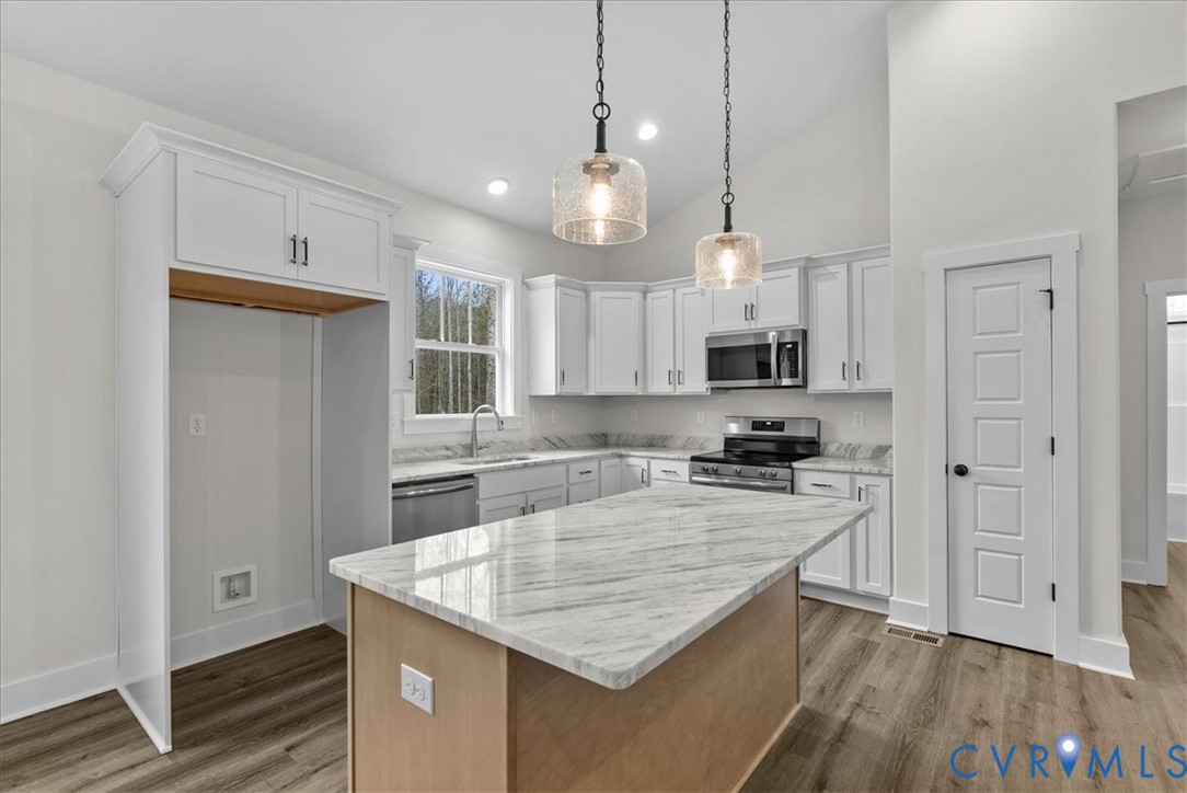 431 Raleigh Avenue South Hill, VA 23970 - Photo 3 of 27 a kitchen with kitchen island a counter space a sink and appliances