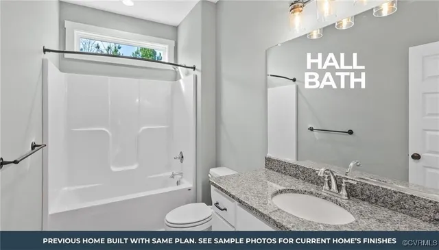 a bathroom with a granite countertop sink a mirror a bathtub and shower