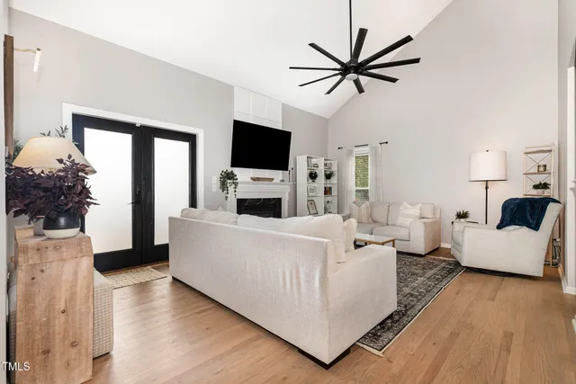 a living room with granite countertop furniture and a flat screen tv