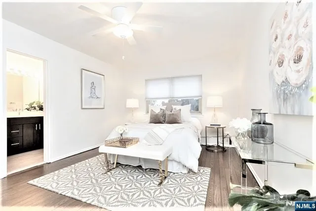 a bed room with a bed and a night stand