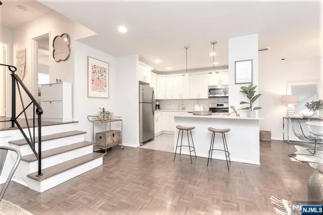 a kitchen with stainless steel appliances kitchen island granite countertop a sink and cabinets