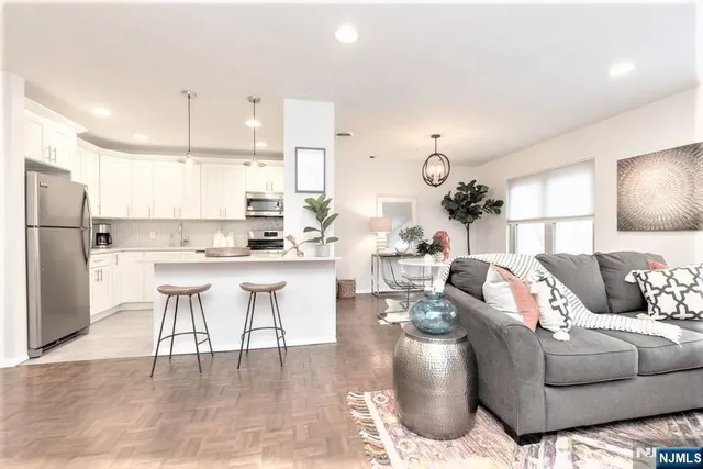 a living room with furniture and kitchen view