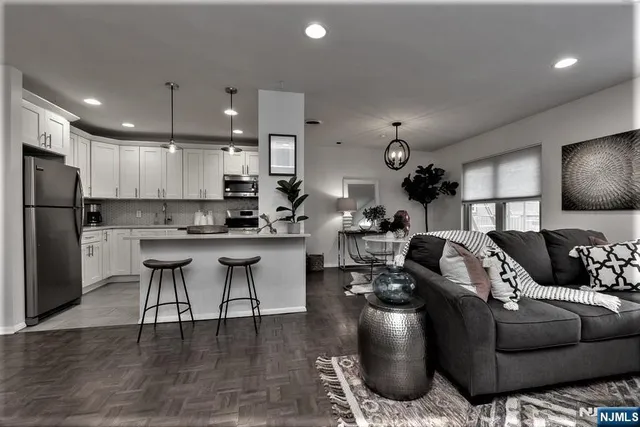a living room with furniture and kitchen view