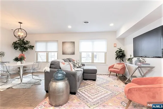 a living room with furniture chandelier and a window