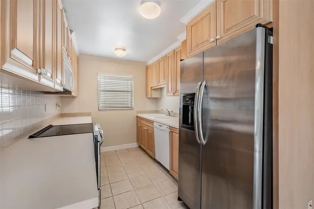 a kitchen with a refrigerator and a sink