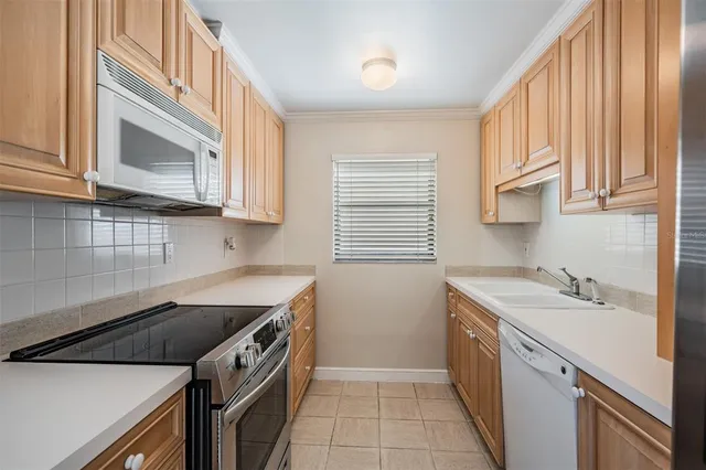 a kitchen that has a sink and a stove