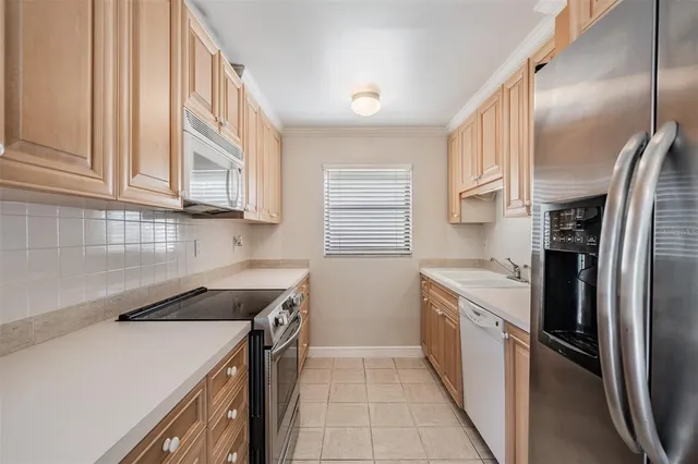 a kitchen with a sink stove and refrigerator
