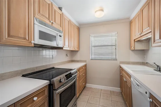 a kitchen with a sink stove and cabinets