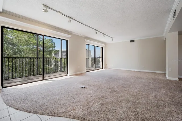 a view of an empty room with a balcony