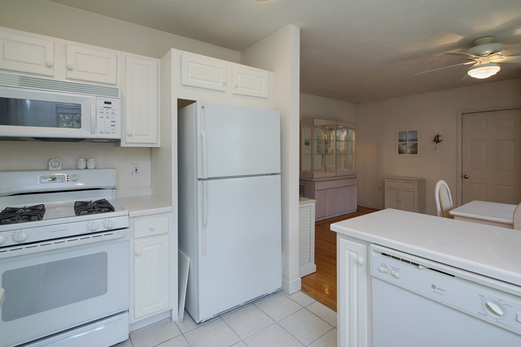 12 Stratford Ridge, Unit 12 Mashpee, MA 02649 - Photo 14 of 27 a kitchen with a refrigerator sink stove and cabinets