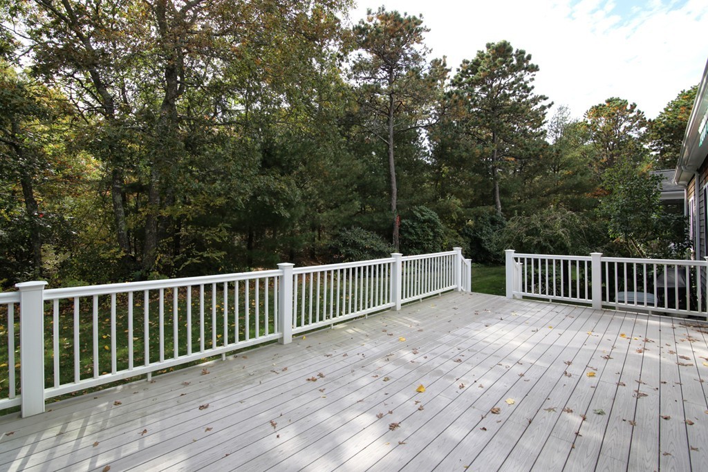 12 Stratford Ridge, Unit 12 Mashpee, MA 02649 - Photo 21 of 27 a balcony with wooden floor and fence