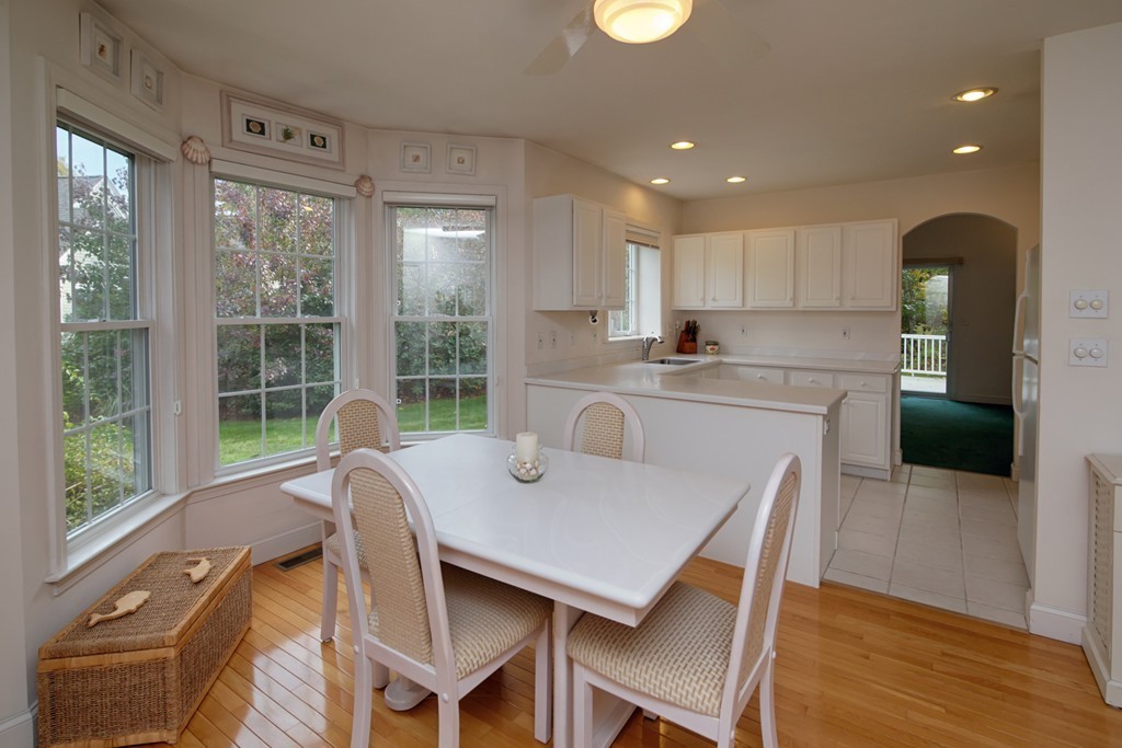 12 Stratford Ridge, Unit 12 Mashpee, MA 02649 - Photo 9 of 27 a view of a dining room with furniture window and wooden floor