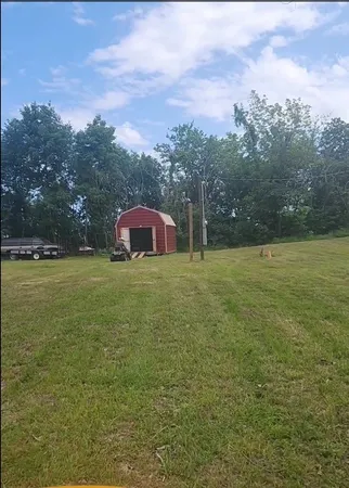 a view of a field with an trees in the background